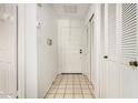 Bright hallway with white doors, tiled floor, and closet space at 5200 S Lakeshore Dr # 206, Tempe, AZ 85283