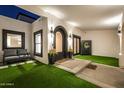 Inviting entryway with manicured lawn, outdoor seating, accent lighting, and charming arched doorway at 5404 N 41St St, Phoenix, AZ 85018