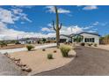 Inviting single-Gathering home with desert landscaping, a circular driveway, and a side entrance at 5670 E Singletree St, Apache Junction, AZ 85119