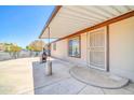 Spacious covered back porch with concrete flooring and access to home at 6921 W Wanda Lynn Ln, Peoria, AZ 85382