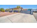 Wide driveway with desert landscape design surrounding the single story home at 6921 W Wanda Lynn Ln, Peoria, AZ 85382