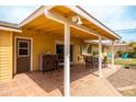 Charming covered patio with tile flooring, a dining area, and a built-in bar, perfect for outdoor entertaining at 7307 N 17Th Ave, Phoenix, AZ 85021