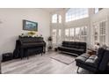 Bright living room with high ceilings, large windows and neutral decor at 7460 E Kiowa Ave, Mesa, AZ 85209