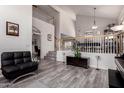 Open-concept living area with staircase, stylish flooring and neutral color palette at 7460 E Kiowa Ave, Mesa, AZ 85209