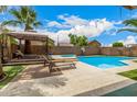 Backyard pool area with lounge chairs, a gazebo, and privacy walls and landscaping at 8214 S 48Th Dr, Laveen, AZ 85339