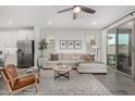 Bright living room with a sectional sofa, stylish rug, and sliding glass doors at 9418 W Minnezona Ave, Phoenix, AZ 85037