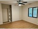 Bedroom with new flooring, ceiling fan, closet and view to the backyard at 1149 S 98Th St, Mesa, AZ 85208