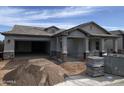 New construction home showing front elevation with two car garage and covered front porch at 1171 E Peach Tree Dr, Chandler, AZ 85249