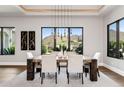 Bright dining room with mountain views, a modern chandelier, and a wood table with seating for six at 13750 E Yucca St, Scottsdale, AZ 85259