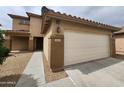 Charming home featuring a two-car garage, desert landscaping, and a welcoming entrance at 13921 W Port Royale Ln, Surprise, AZ 85379