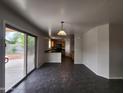 Open floor plan showcasing tile flooring with views of the kitchen and sliding glass doors at 13921 W Port Royale Ln, Surprise, AZ 85379