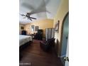 Bedroom with vaulted ceilings, a ceiling fan, wood floors, and a comfortable-looking bed at 14617 S 35Th Pl, Phoenix, AZ 85044