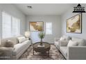Bright living room, virtually staged, with a neutral color scheme and ample natural light at 14881 W Ashland Ave, Goodyear, AZ 85395