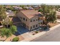 Expansive aerial view of a two-story home highlighting the roof, large driveway, and surrounding neighborhood at 16206 W Cocopah St, Goodyear, AZ 85338