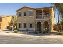 Charming home featuring a welcoming porch, desert landscaping, and an American flag on the balcony at 16206 W Cocopah St, Goodyear, AZ 85338