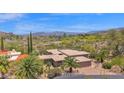 An aerial view of a desert home, golf course, and mountain views at 1702 E Staghorn Ln, Carefree, AZ 85377