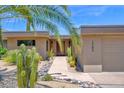 Desert home with lush landscaping and modern architecture at 1702 E Staghorn Ln, Carefree, AZ 85377