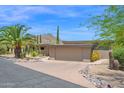 Desert home with lush landscaping, private drive, and two-car garage at 1702 E Staghorn Ln, Carefree, AZ 85377