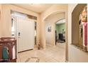 Inviting foyer with tile flooring, arched doorways, and a view into the adjacent living spaces at 17651 N Coconino Dr, Surprise, AZ 85374