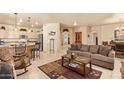 Open-concept living room showcasing tile floors, a comfortable sofa, and seamless flow to the kitchen at 17651 N Coconino Dr, Surprise, AZ 85374