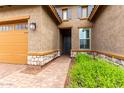 Inviting front entrance with beautiful stone accents, desert landscaping, and a brick paved walkway at 18453 W Elwood St, Goodyear, AZ 85338