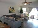 Open living room showcasing modern furniture, ceiling fan, and access to backyard at 18599 W Illini St, Goodyear, AZ 85338