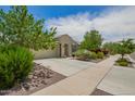 Lovely single-story residence with a desert landscape and long driveway at 18653 W Mescal St, Surprise, AZ 85388