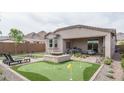 Entertainer's backyard with mini golf, fire pit, mountain views, and covered patio at 20961 W Pasadena Ave, Buckeye, AZ 85396