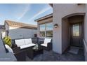 A lovely entryway with outdoor furniture, showing a view to the home's entrance at 20961 W Pasadena Ave, Buckeye, AZ 85396