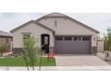 Charming single-story home with stone accents, neutral color scheme, and two car garage at 20961 W Pasadena Ave, Buckeye, AZ 85396