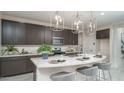 Stylish kitchen features sleek cabinetry, stainless steel appliances, and marble countertops at 20961 W Pasadena Ave, Buckeye, AZ 85396