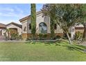 A green front yard with lawn and shade trees frames this lovely single-story home at 211 W New Dawn Dr, Chandler, AZ 85248