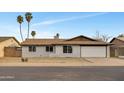 Charming single-story home with brick exterior, desert landscaping, a two-car garage, and tall palm trees in the front yard at 2123 E Radcliffe Dr, Tempe, AZ 85283