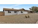 Single-story home with painted brick exterior, gravel front yard, two-car garage, and walkway to the front door at 2123 E Radcliffe Dr, Tempe, AZ 85283