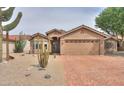 Inviting home with desert landscaping, showcasing the driveway and facade in a sunny neighborhood at 2395 E Hancock Trl, Casa Grande, AZ 85194