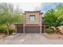 Delightful two-story home featuring a tile roof, desert landscaping, and a two-car garage at 28136 N 90Th Ln, Peoria, AZ 85383