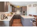 Modern kitchen featuring gray cabinets, stainless appliances, countertops, and a center island at 28136 N 90Th Ln, Peoria, AZ 85383