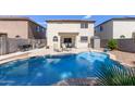 Enjoy the Arizona sunshine in this home's backyard pool and patio area at 4771 E Meadow Land Dr, San Tan Valley, AZ 85140
