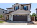 Attractive two-story home featuring a tile roof, shutters, and an attached two-car garage at 4771 E Meadow Land Dr, San Tan Valley, AZ 85140