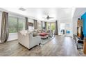Spacious living room with hardwood floors, a ceiling fan, and lots of natural light at 660 W Twin Peaks Pkwy, San Tan Valley, AZ 85143