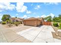 Side view of home with a two-car garage and additional parking space at 7214 W Crest Ln, Glendale, AZ 85310