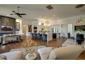 Open-concept living room flowing into a modern kitchen with a marble island, hardwood floors, and upscale decor at 7904 E Quill Ln, Scottsdale, AZ 85255