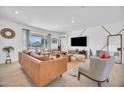 Inviting living room featuring a comfortable leather sofa, large window, modern decor and lots of room for friends and Gathering at 8614 E Rose Ln, Scottsdale, AZ 85250
