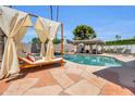 Beautiful pool area features a covered lounge, spa, pizza oven and hammocks that create a perfect oasis for relaxation and enjoyment at 8614 E Rose Ln, Scottsdale, AZ 85250