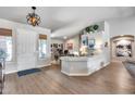 Inviting entryway with wood floors leading to an office space and living area at 8738 W Runion Dr, Peoria, AZ 85382