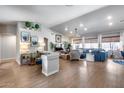 Bright living room with hardwood floors, a vaulted ceiling, and stylish blue sofa at 8738 W Runion Dr, Peoria, AZ 85382