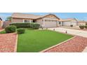 Welcoming single-story home with a manicured lawn and desert landscaping and attached garage at 10521 W Ross Ave, Peoria, AZ 85382