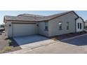 Spacious two-car garage with a modern exterior design, enhancing the home's functionality and aesthetic at 1057 S 151St Ln, Goodyear, AZ 85338