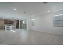 Bright, open-concept living room featuring tile flooring, recessed lighting, and abundant natural light at 1057 S 151St Ln, Goodyear, AZ 85338