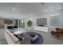 Stylishly furnished living room with modern decor, an open layout, and abundant natural light at 1057 S 151St Ln, Goodyear, AZ 85338